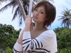 Giggling chick Miyu Oriyama walks along the beach and shows her splendid body